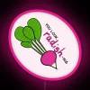 Neon sign with vibrant pink lettering spelling out 'Radish' in bold, cursive font.