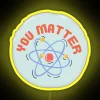 Atoms that matter: An atomic design element in bright neon yellow.
