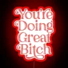 Neon pink sign with bold, cursive text reading "You're Doing Great" in a fun, empowering tone.