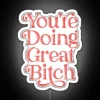 You're doing great, Bitch" neon sign in pink and red colors.