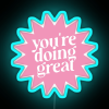Colorful neon sign with pink LED lights displaying a motivational phrase.