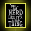 A person holding a neon sign that reads 'You Say Nerd Like It's a Bad Thing'