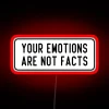 Neon sign reading 'Your emotions are not facts' in bold red letters.