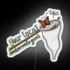 A neon sign reading "Your Local Entomologist" in bold, colorful letters.