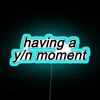 A neon sign reading 'Your Name Moment' in blue letters.