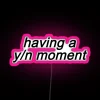 Neon sign with colorful letters spelling out 'Your Name Moment'
