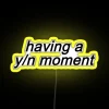 Neon sign with a personalized name in bold yellow letters on a dark background.