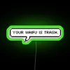 Neon sign with bold, colorful letters reading 'Your waifu is trash' in a playful, humorous tone.