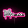 A pink neon sign with a cartoon cat character saying "stupid" in Japanese (yuki).