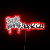 Cute cat standing under a colorful neon sign