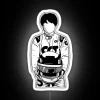 F1 driver Yuki Tsunoda standing in front of an RGB neon sign