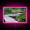 Vibrant pink neon sign with zigzag design in bright RGB colors.