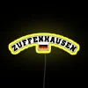 Porsches iconic Zuffenhausen factory illuminated at night with vibrant RGB neon lights.