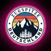 Neon sign in front of the Zugspitze mountain peak in Germany