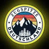 Neon-lit Zugspitze mountain peak in Germany with vibrant yellow hues.